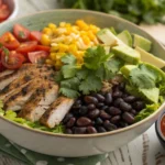 Colorful taco bowl meal prep with seasoned ground beef, chicken, fresh vegetables, and beans.